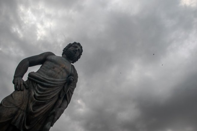 Wolken über der Statue des Asklepios in der Stadt Trikala
