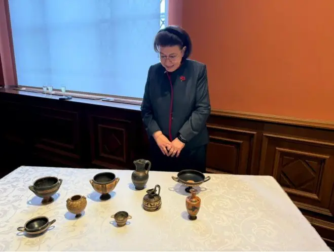 Unser Foto (© Eurokinissi) zeigt Kulturministerin Lina Mendoni mit den neun antiken Gefäßen.