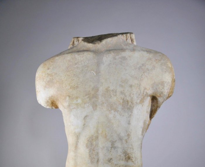 Foto (© yppo): Der Marmortorso eines Kouros, um 560 v. Chr., vermutlich aus Böotien, und der Bronzekopf eines Greifs von einem Kessel, um 660-663 v. Chr., aus Samos.