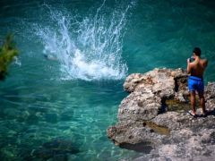 Die Badefreude an Griechenlands Küsten bleibt ungetrübt – auch der Hasenkopfkugelfisch hält die Menschen nicht vom Sprung ins Meer ab. Foto (© Eurokinissi)